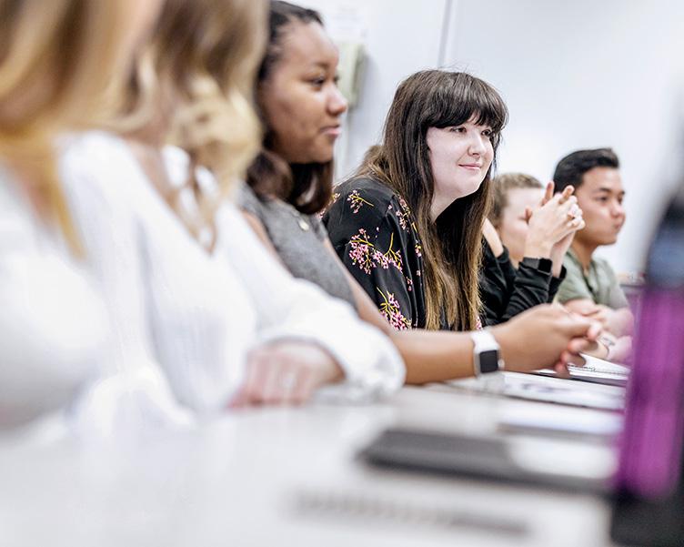 Students talking in a classroom.